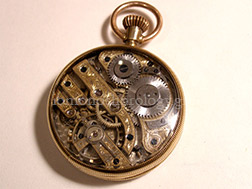 Engraving by hand on an antique pocket watch's movement